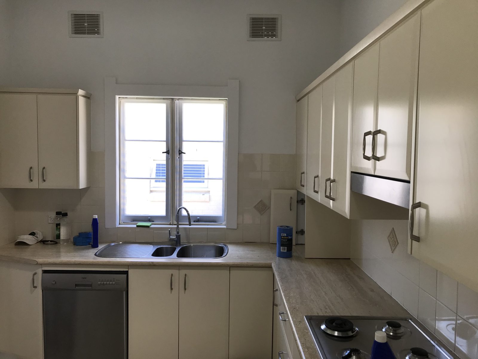 The same kitchen before, with dated cream cabinets