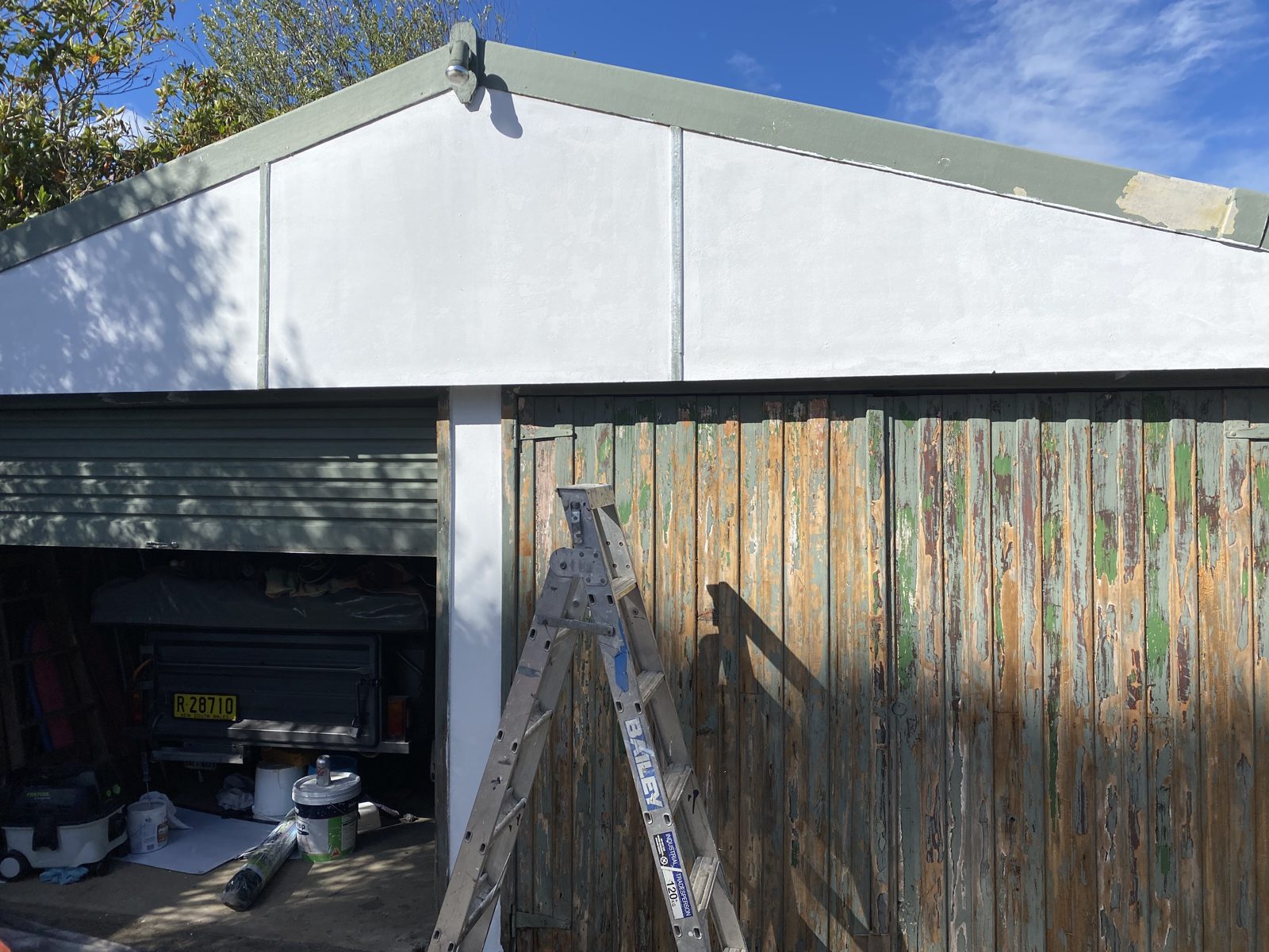 The same garage before, with old, flaking, weathered paint