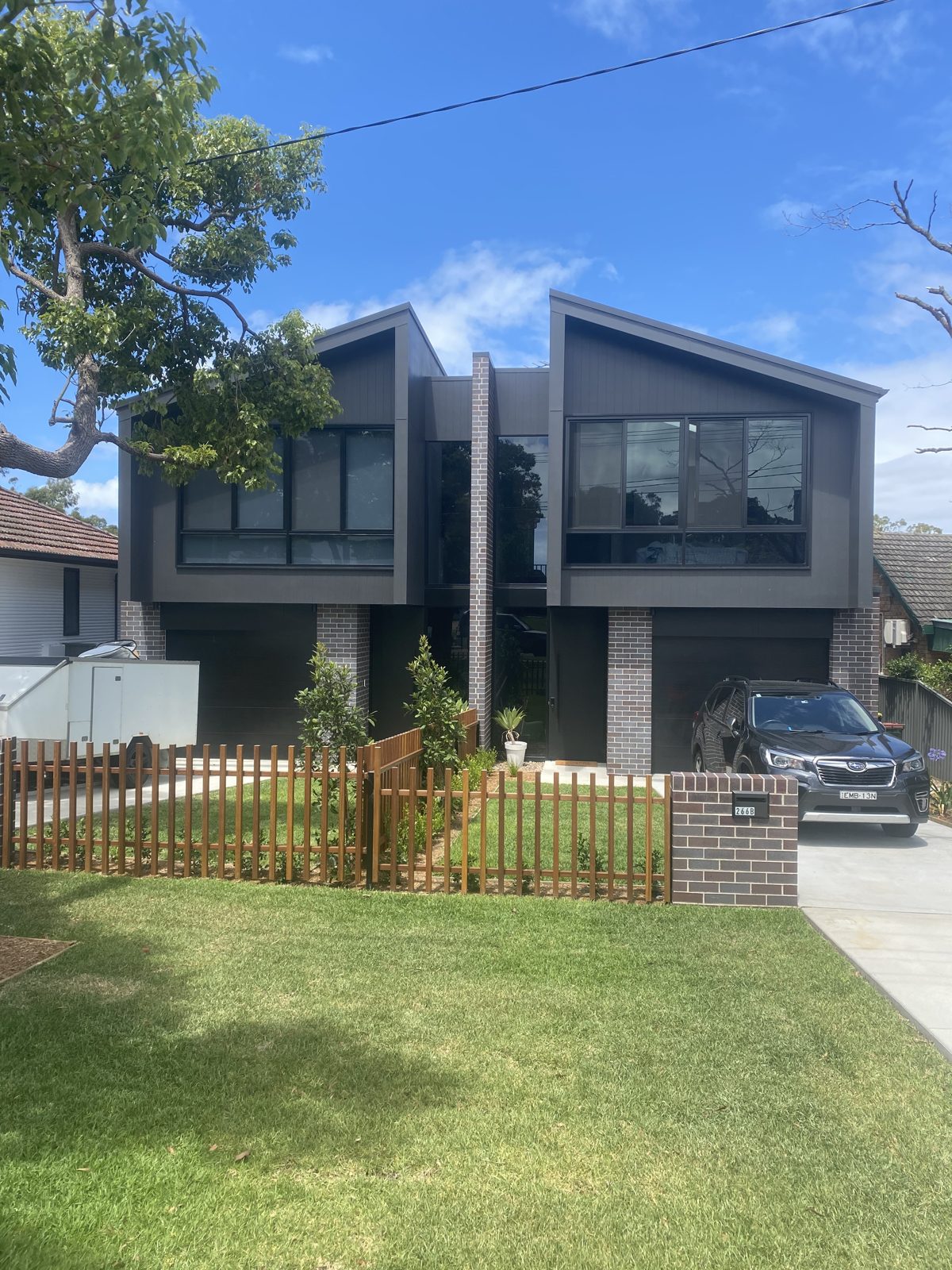 A freshly repainted two-storey Sydney home with a charcoal exterior by OJAY Painting