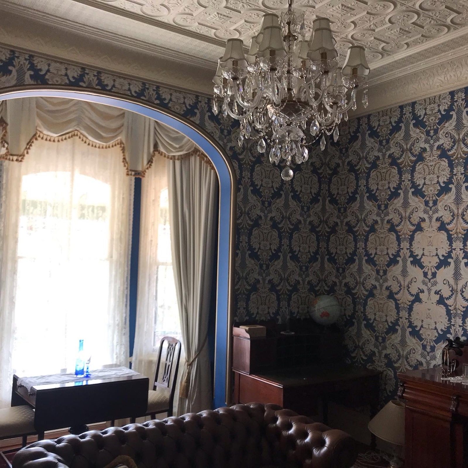 A grand period interior with ornate ceiling and freshly finished walls