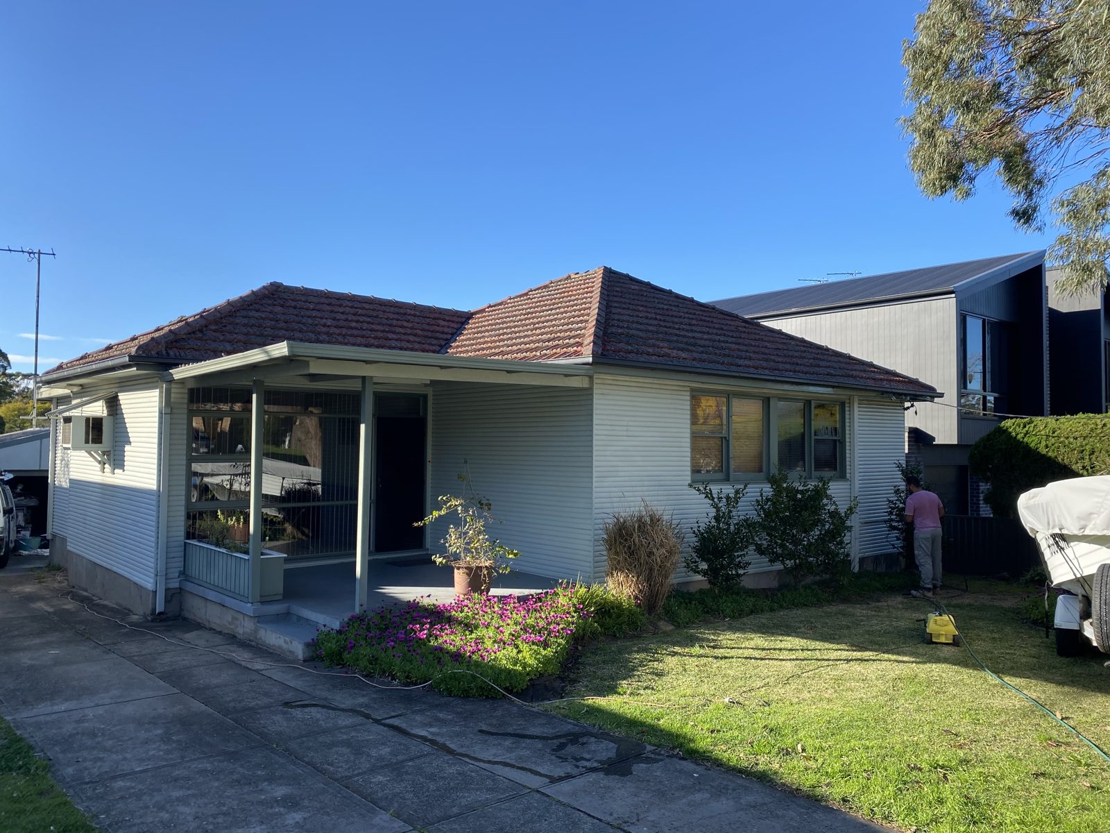 Prepping and washing down the exterior of a home before repainting
