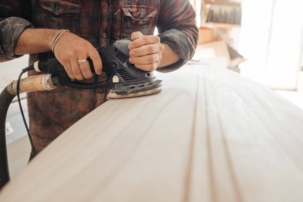 Old paint being sanded back to a sound surface